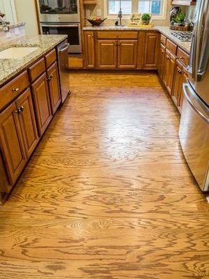 52497896 - shiny hardwood floor in new kitchen with granite countertops and stainless steel appliances
